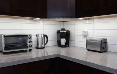 a kitchen counter with a toaster oven and a microwave at Casa Hotel Stylish Modern Family Suite with Patio in Toronto