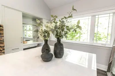 two vases sitting on top of a table with flowers at Luxury 4BR Stay with Swim Spa, Golf and Fireplaces in Caledon