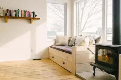 a living room with a couch and a fireplace at Wellington Waterfront Home in Wellington