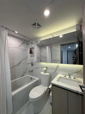 a bathroom with a toilet and a tub and a sink at Entire Luxe Condo in Downtown Toronto in Toronto