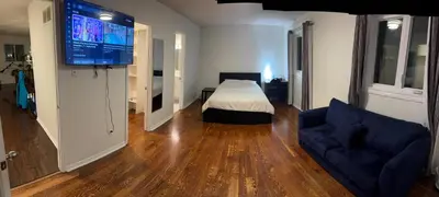 a living room with a bed and a flat screen tv at VP1 master bedroom on second floor in Mississauga