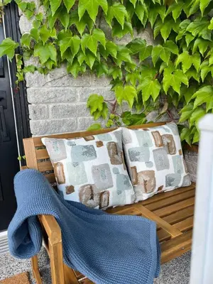 a chair and pillows on a bench next to a wall at Barrie Hideaway in Barrie