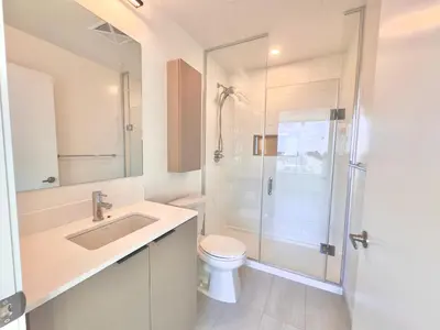 a bathroom with a shower and a toilet and a sink at Paradise - 2 Bedroom modern, cozy and luxury living in Mississauga