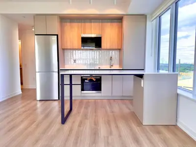 a kitchen with a counter with a refrigerator at Paradise - 2 Bedroom modern, cozy and luxury living in Mississauga