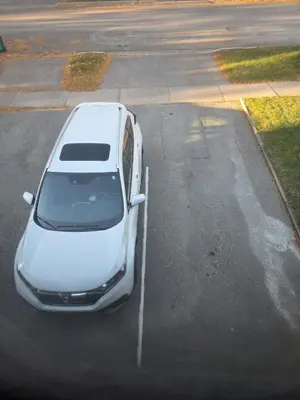 a white car parked in a parking lot at Togather Time,5 minutes to HYW 401 in Oshawa