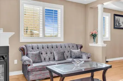 a living room with a couch and a table at Luxury Mansion by Toronto and YYZ with Large Backyard Weddings in Brampton