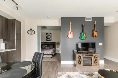 a living room with guitars hanging on the wall at Modern 1 Bedroom Condo Front Street Downtown Toronto in Toronto