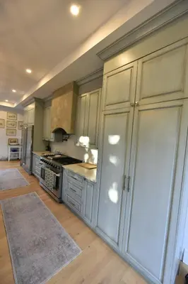 a large kitchen with white cabinets and a stove at Luxury Countryside Villa in Waterford