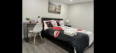 a bedroom with a bed and a desk and a chair at Master bedroom in Mississauga