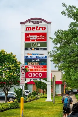 a sign in front of a store with signs on it at Spacious 3-Bedroom SkyLoft with Beautiful City Views and Parking in Toronto