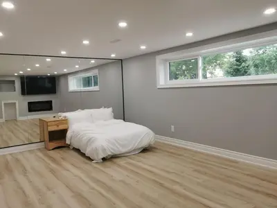 a bedroom with a bed and a desk and a window at 5 Bed 4Bath 9 Parking Lakeside Retreat in Ajax