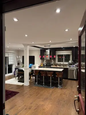 a large kitchen with a table and a dining room at Home in Scarborough, near GO station, TTC and UoT in Toronto
