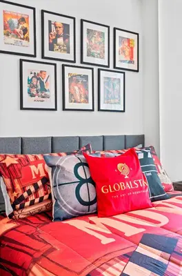 a bedroom with a bed with posters on the wall at 1 Bedroom Condo with Balcony Fort York Downtown Toronto in Toronto