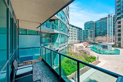 an apartment balcony with a view of a city at 1 Bedroom Condo with Balcony Fort York Downtown Toronto in Toronto
