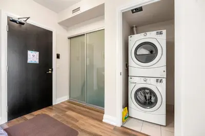 a laundry room with a washer and dryer at High Floor 1 Bedroom plus Den Condo Apartment City View North York Toronto in Toronto
