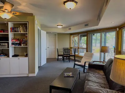 a living room with a couch and a table at Private Lakefront Cottage Living on Muldrew Lake in Gravenhurst