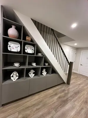 a living room with a staircase with shelves at Spacious 2 Bedroom & 2 Bathroom Suit Near Fairview Mall & Waterloo Airport in Kitchener