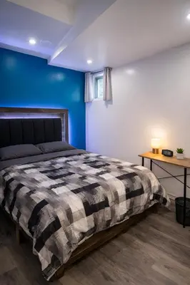 a bedroom with a bed and a blue wall at Private Room In Cambridge B13 in Cambridge