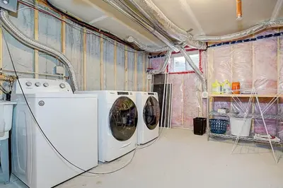 a laundry room with a washer and dryer in it at Downsview Park Luxury Townhome near Yorkdale Transit in Toronto