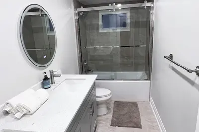 a bathroom with a sink and a toilet and a mirror at Beautiful Lake Side Neighbourhood Home in Ajax, ON in Ajax