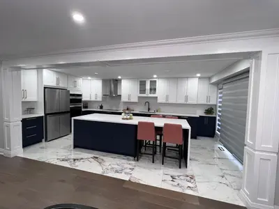 a kitchen with white cabinets and a island with chairs at Beautiful Lake Side Neighbourhood Home in Ajax, ON in Ajax