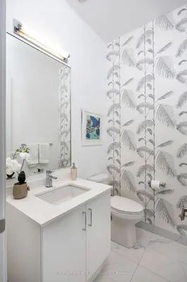 a white bathroom with a sink and a toilet at Waterfront Modern Vila in Innisfil