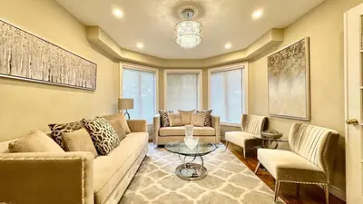 a living room with a couch and chairs and a table at Designer 4BR Retreat, Luxe Living & Family-Friendly Fun in Mississauga
