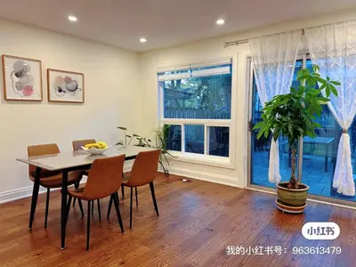 a dining room with a table and chairs and a window at Quiet Queen Bedroom near Finch Birchmunt in Toronto