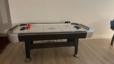 a ping pong table sitting in a room at Family friendly place with pool in Penetanguishene