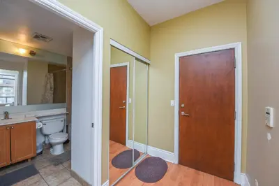 a bathroom with a toilet and a mirror at PlanURstay - Ideal 2BR & 2 BTH - Near SQ1 Mall in Mississauga