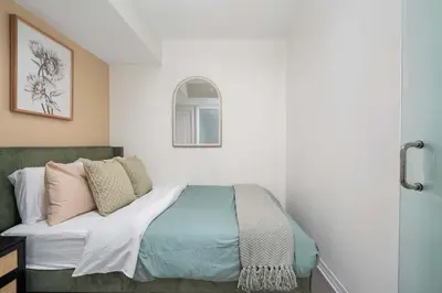 a bedroom with a bed with pillows on it at Chic 2BR Condo Toronto Core Steps to Eaton Centre in Toronto