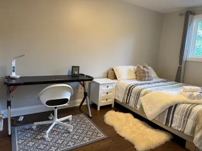 a bedroom with a desk and a bed and a chair at Quite room finch birchmunt in Toronto