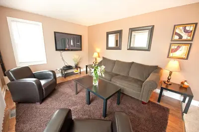 a living room with a couch and a table at Misty Retreat in Niagara Falls