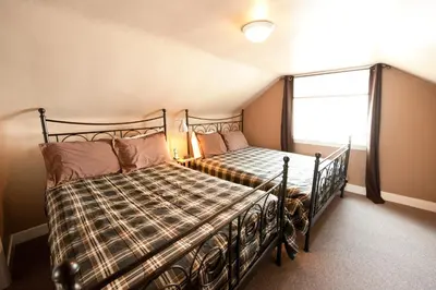 a bedroom with a bed and a window at Misty Retreat in Niagara Falls