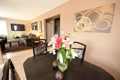 a vase of flowers on a table in a living room at Misty Retreat in Niagara Falls