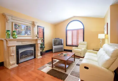a living room with a couch and a fireplace at STONEHAVEN RETREAT in Niagara Falls