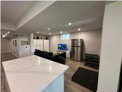 a kitchen and living room with a white counter top at 1-Bedroom 1Bathroom Entire Unit closer to Fairview Mall & Waterloo Airport in Kitchener