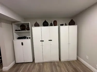 three white cabinets in a room with vases at 1-Bedroom 1Bathroom Entire Unit closer to Fairview Mall & Waterloo Airport in Kitchener