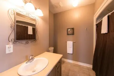 a bathroom with a sink and a mirror at PRESIDENTIAL SUITE in Niagara Falls