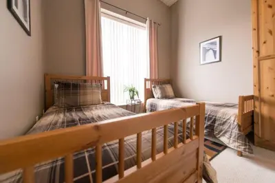 a bedroom with two beds and a window at PRESIDENTIAL SUITE in Niagara Falls