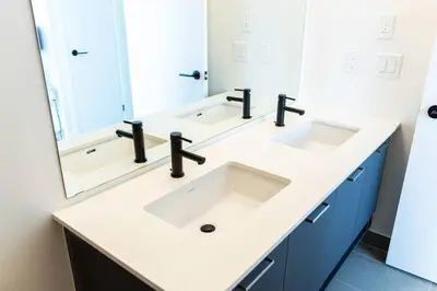 a bathroom with two sinks and a large mirror at Spacious 3BR Loft with Balcony and Free Parking in Toronto