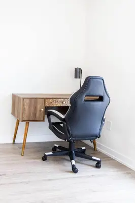 a black office chair sitting in front of a wooden desk at Spacious 3BR Loft with Balcony and Free Parking in Toronto