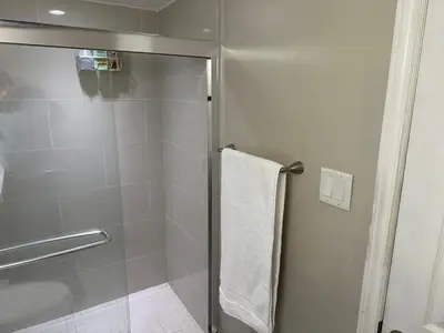 a bathroom with a shower with a white towel at Cozy and comfy 2 Bed rooms in Mississauga