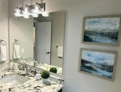 a bathroom with a sink and a large mirror at Fieldstone Estate in Tillsonburg
