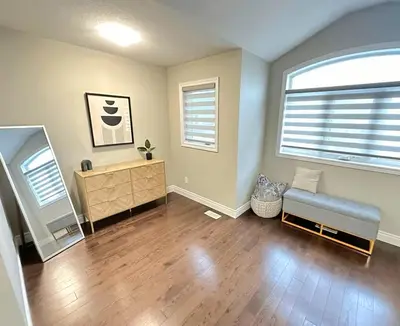 a living room with a bench and a mirror at Fieldstone Estate in Tillsonburg