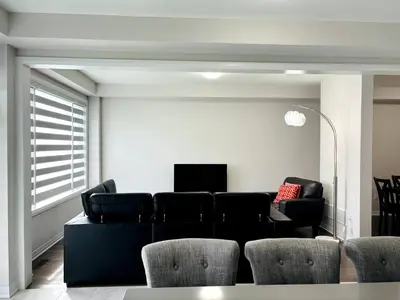 a living room with a black couch and chairs at Cozy Private Room with ensuite in Shared Home in Ayr in Paris