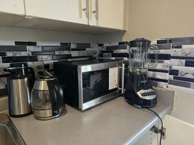 a kitchen counter with a blender and a microwave at Simple entire apartment 2 bedroom night rest in Kitchener