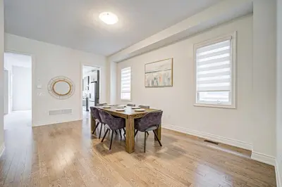 a dining room with a table and some chairs at Modern Spacious Luxury detached-House new in RH in Richmond Hill