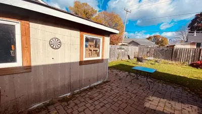 a small house with a blue table in the yard at Soft Landing Spot Basement Hideout 2 bedroom apartment in Ajax