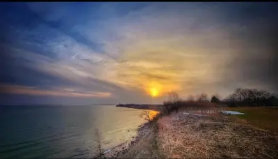 a sunset over a body of water with the sun in the sky at Soft Landing Spot Basement Hideout 2 bedroom apartment in Ajax